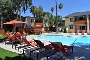 Canoga Park apartment for rent - View from pool area with lounge chairs and seating area, and spa