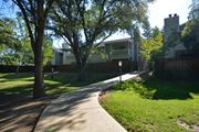 Citrus Heights apartment for rent - Exterior view of buildings with private patio/balcony, side walk winding in between with lush grass area and pet stations