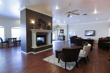 Bossier City apartment for rent - a living room with a fireplace and a table and chairs