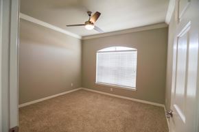 Bossier City apartment for rent - View of bedroom with carpet floors, ceiling fan, and well lit window