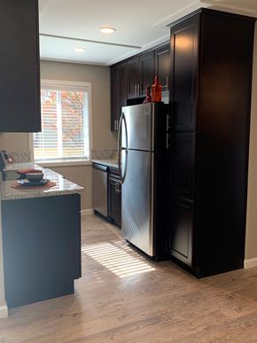 Tracy apartment for rent - View of kitchen with brown cabinets, wood like flooring, stainless appliances, and well lit window in kitchen