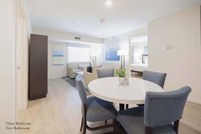 Richardson apartment for rent - a living room and dining room with a white table and chairs at Parks Residential - Richardson, Texas, 75082