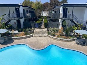 Torrance apartment for rent - Pool view at Americana South Bay with seating areas, and view of buildings closest to pool