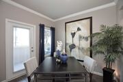 Roseville apartment for rent - a dining room with a table and chairs and a painting on the wall