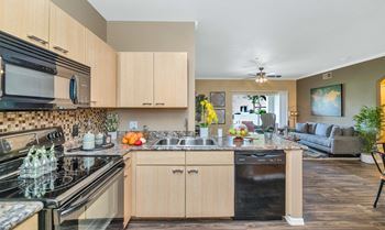 The view of a kitchen and living room with a couch