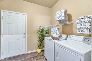 The washer and dryer in a laundry room with a white door
