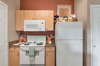 A kitchen with a stove microwave and refrigerator