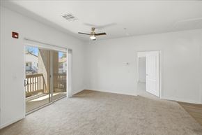 Prescott Valley apartment for rent - A spacious room with a ceiling fan and a carpeted floor.