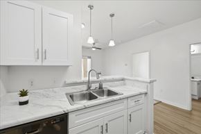 Prescott Valley apartment for rent - A kitchen with white cabinets and a marble countertop.