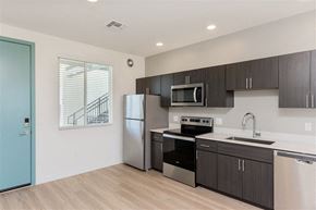 Scottsdale apartment for rent - A kitchen with a blue door and stainless steel appliances.at The 89 on Hayden, Scottsdale  