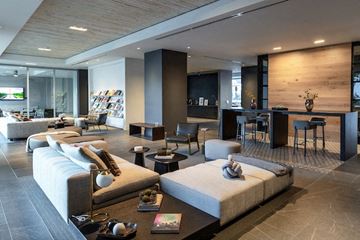 Phoenix apartment for rent - A modern living room with a large couch and a coffee table.