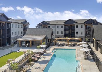 A large building with a pool in front