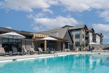 A large swimming pool in front of a resort
