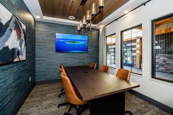 A conference room with a long table and chairs