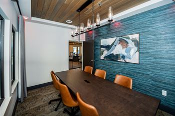 A conference room with a long table and chairs