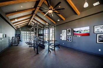 A room with a ceiling fan and pictures on the wall