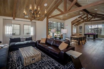 Prescott Valley apartment for rent - A modern living room with a dark brown leather couch and a wooden coffee table.