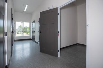 A room with a grey floor and a grey door