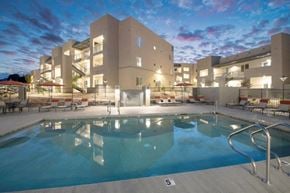 Cottonwood apartment for rent - a swimming pool with palm trees in front of a building at Inspiration Apartments, Cottonwood