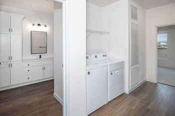 A bathroom with a washer and dryer in it
