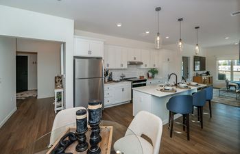 A modern kitchen with white cabinets and a large island