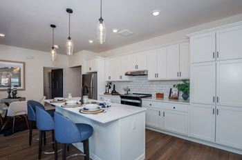 A modern kitchen with a dining table and chairs