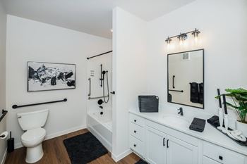 A bathroom with a toilet, sink, and mirror
