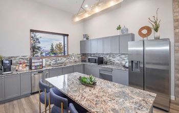 A kitchen with stainless steel appliances and granite counter tops