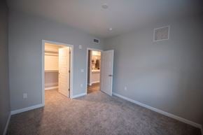 Cottonwood apartment for rent - a bedroom with a closet and a door to a bathroom at Inspiration Apartments, Cottonwood, AZ, 86326