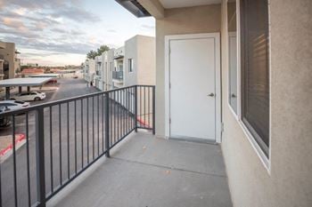The door to the balcony of a building with a white door