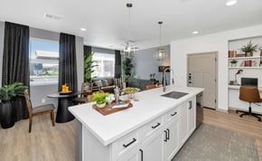 Gilbert apartment for rent - Luxury Apartments in Gilbert, AZ with In-Unit Washer and Dryer - Everly - Gourmet Kitchen Island with Custom Cabinetry, Quartz Countertop, Pendant Lights, Wood-Style Plank Flooring, and View of Dining Area and Living Room.