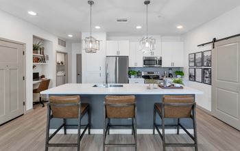 Gourmet kitchen with custom cabinetry, quartz countertops & tile backsplash