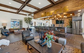 Social clubroom with lounge seating, tvs, tabletop games & outdoor patio