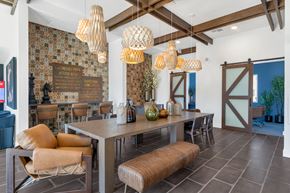 Gilbert apartment for rent - A dining room with a table and chairs and a wallpapered wall.