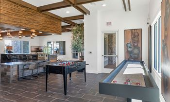 Social clubroom with lounge seating, tvs, tabletop games & outdoor patio