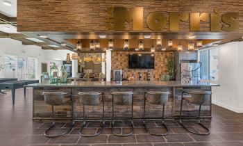 Social clubroom with lounge seating, tvs, tabletop games & outdoor patio