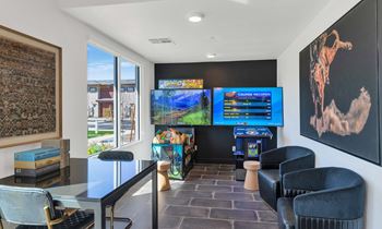 Social clubroom with lounge seating, tvs, tabletop games & outdoor patio