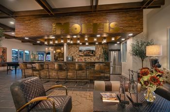 Social clubroom with lounge seating, tvs, tabletop games & outdoor patio