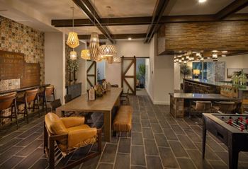 Social clubroom with lounge seating, tvs, tabletop games & outdoor patio