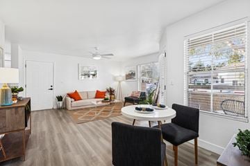 Phoenix apartment for rent - A living room with a white ceiling and a white table with a plant on it.