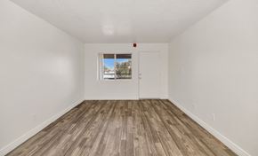Phoenix apartment for rent - A room with a white door and a window with a view of trees and a house at Urban WalkApartments on 6th Avenue, Phoenix, AZ
