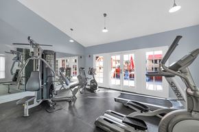 Phoenix apartment for rent - A gym with a variety of equipment including treadmills, stationary bikes, and weight machines at Urban WalkApartments on 6th Avenue, Phoenix 85016