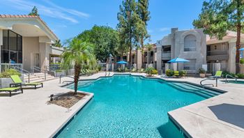 Poolside loungers & patio tables with umbrellas