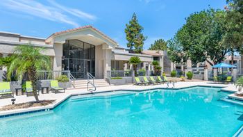 Poolside loungers & patio tables with umbrellas