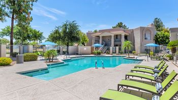 Poolside loungers & patio tables with umbrellas