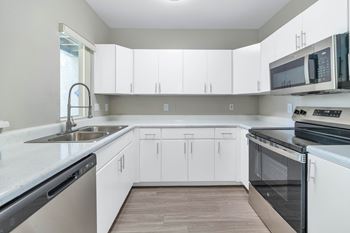 White kitchens with stainless steel appliances*