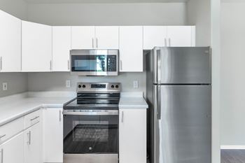 White kitchens with stainless steel appliances*