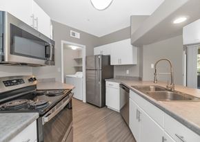 Chandler apartment for rent - A modern kitchen with a stove top oven and a refrigerator.