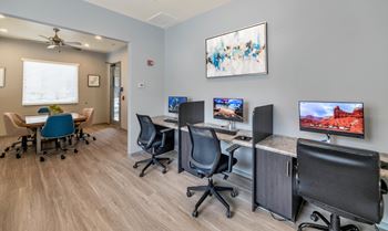 Computer workspace with individual desks and monitors