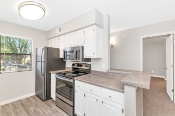 Scottsdale apartment for rent - a kitchen with white cabinets and a stainless steel refrigerator